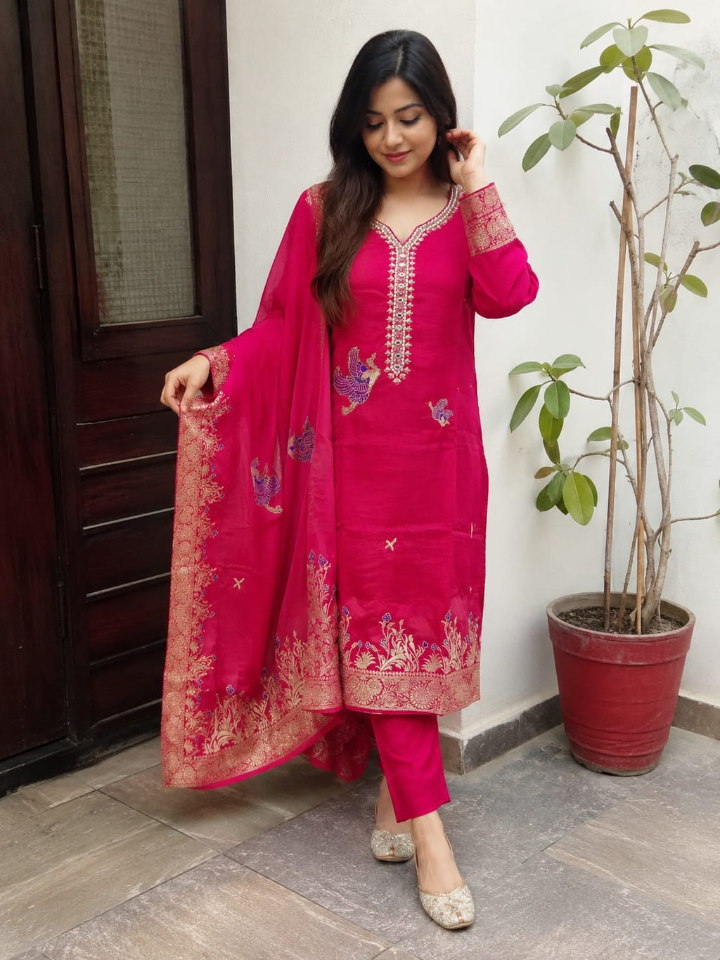 DOLA SILK SUIT IN MAJENTA COLOUR  WITH WORK ON NECK LINE AND BIRDS HIGHLTING  AND CHINNON DUPATTA  FOUR SIDE BORDER