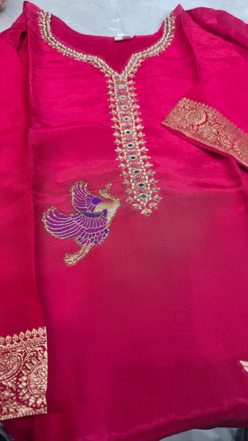 DOLA SILK SUIT IN MAJENTA COLOUR  WITH WORK ON NECK LINE AND BIRDS HIGHLTING  AND CHINNON DUPATTA  FOUR SIDE BORDER