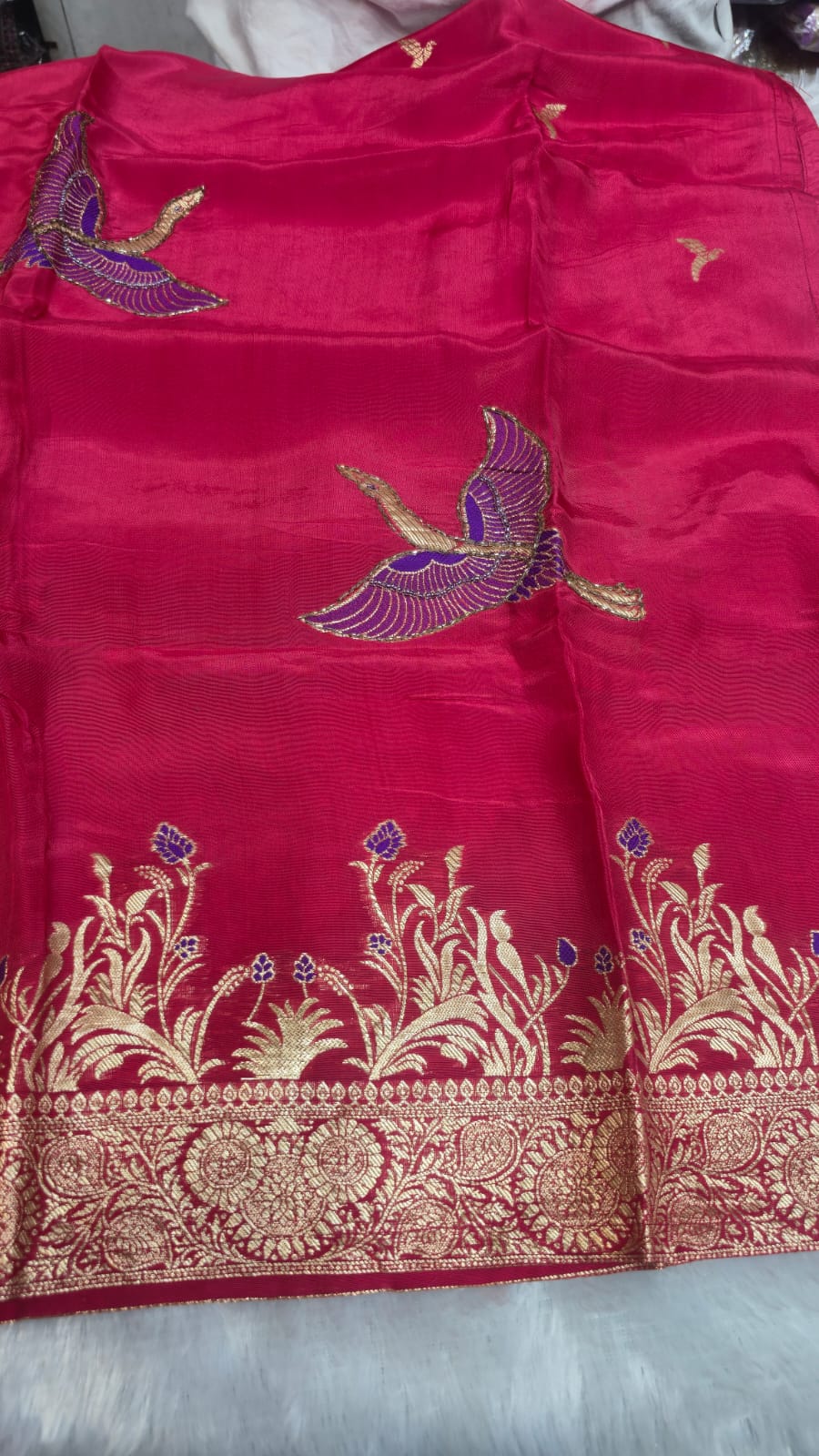 DOLA SILK SUIT IN MAJENTA COLOUR  WITH WORK ON NECK LINE AND BIRDS HIGHLTING  AND CHINNON DUPATTA  FOUR SIDE BORDER