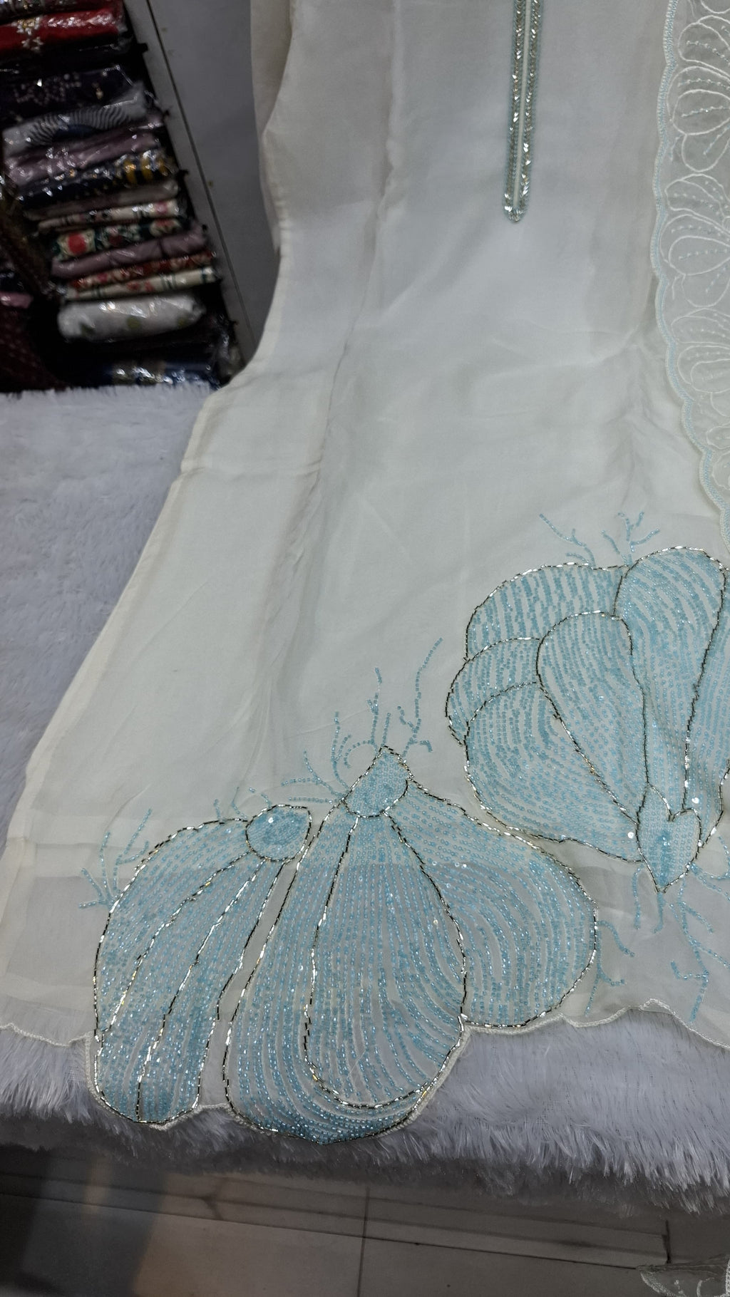 OFF WHITE COLOUR  ORGANZA  SUIT WITH BEAUTIFUL SEQUENCE  WORK NECKLINE  AND BUTTERLIES WITH SEQUENCE ON HEMLINE