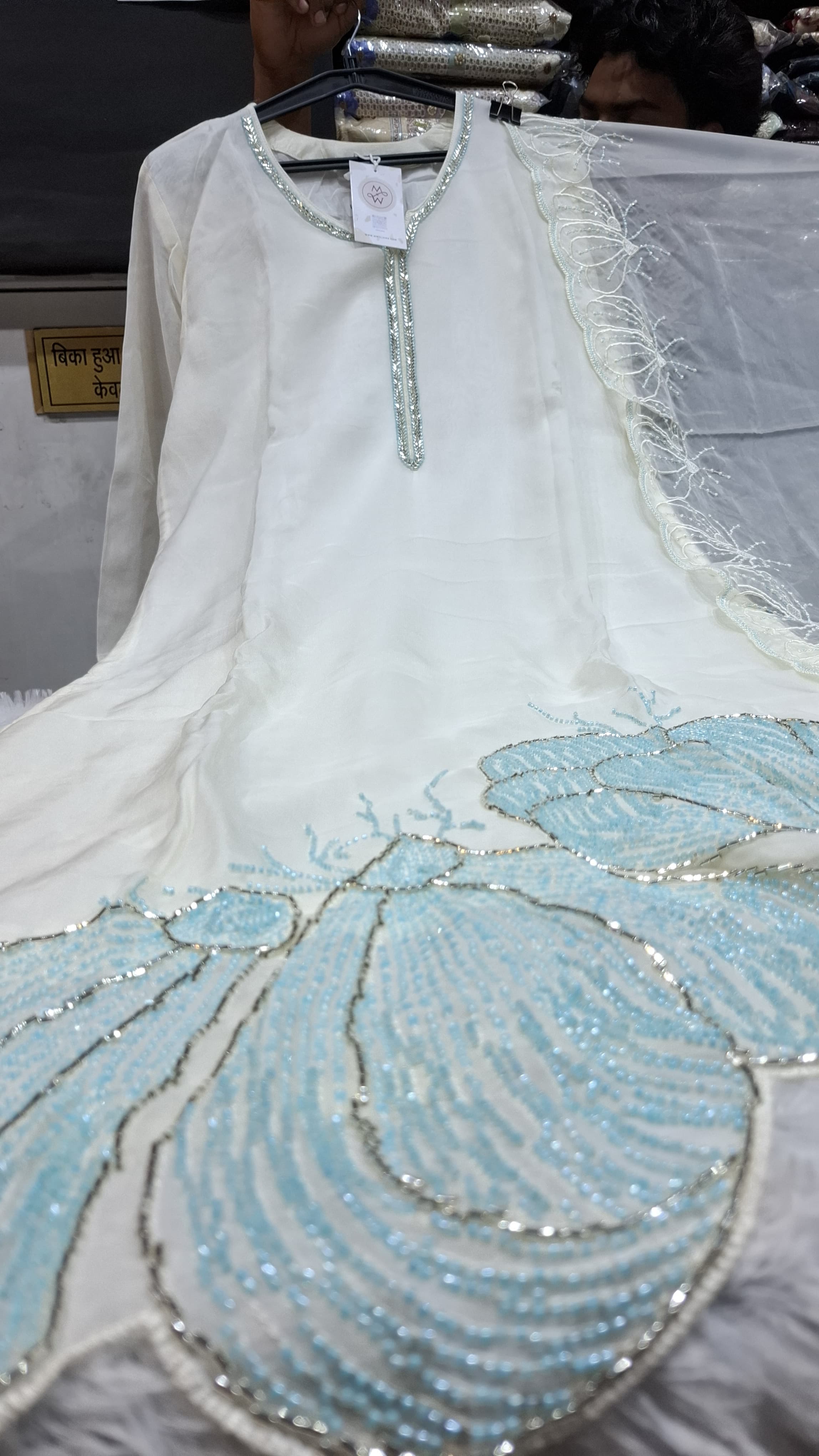 OFF WHITE COLOUR  ORGANZA  SUIT WITH BEAUTIFUL SEQUENCE  WORK NECKLINE  AND BUTTERLIES WITH SEQUENCE ON HEMLINE